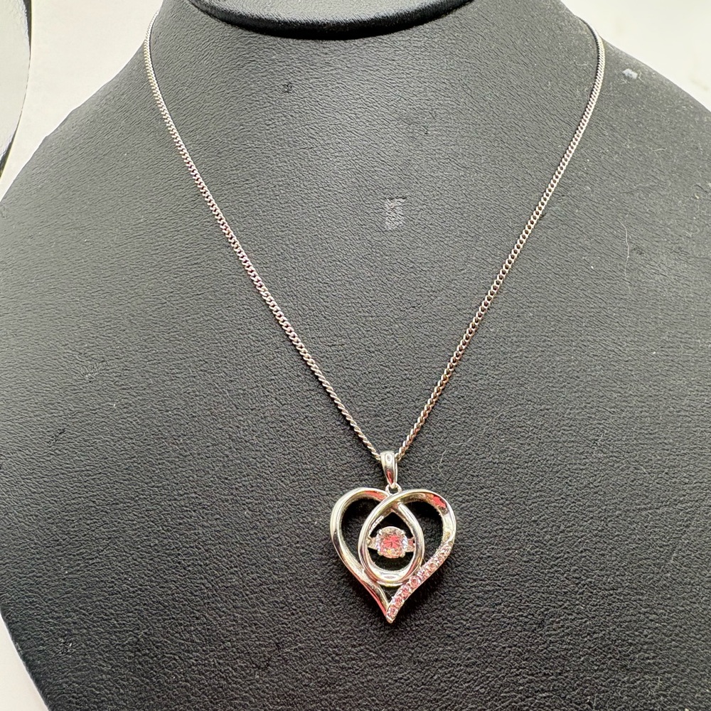 Heart pendant with shiny floating crystal inside